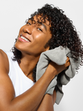 person using  DevaTowel on wet curly hair