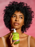 model with curly hair holding Quench'n bottle